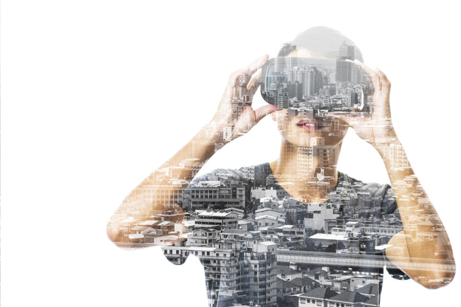 Un hombre mirando a través de unas gafas de realidad virtual visualizando una ciudad. 